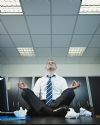 businessman doing yoga in office